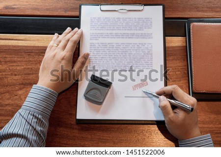 senior business man male hand putting or signing signature in the certificate contract after approve stamp on loan document agreement lawyer hand concept