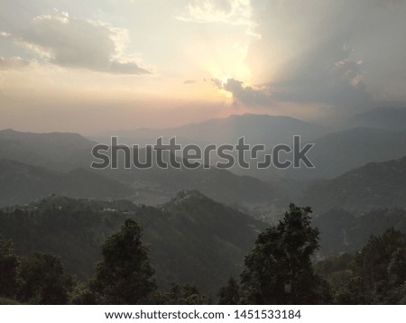 Picture of sunset between beautiful mountains and sky
