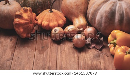 autumn pumpkins and other fruits and vegetables on a wooden thanksgiving table