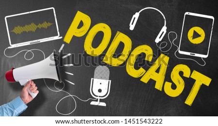 hand of businessman holding megaphone or bullhorn against blackboard with podcasting symbols and text PODCAST