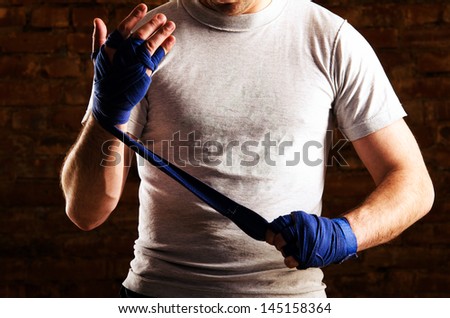 fighter is getting ready against brick wall Royalty-Free Stock Photo #145158364