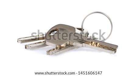 Four house keys on a key ring isolated on a white background.