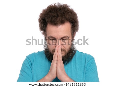 Portrait of caucasian crazy bearded Man with funny Curly Hair - saying prayers, isolated on white background. Religious image - Guy praying and praising God.