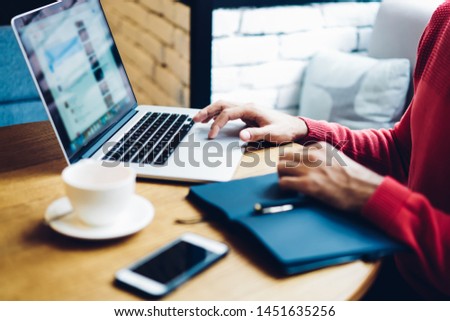 Cropped image of male freelancer working with online website system checking settings and editing program code via modern laptop computer, skilled man developing netbook application connected to wifi