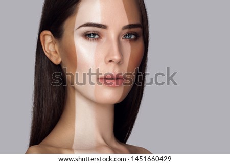 Portrait of beautiful white girl with stripes of different colour Foundation. Sample selection color of makeup. Beauty woman portrait close-up on a gray background. Long straight fair hair Royalty-Free Stock Photo #1451660429