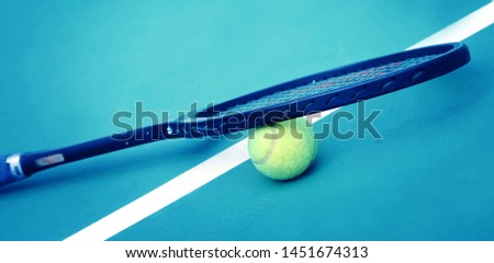 Close up of tennis ball and tennis racket on the tennis court