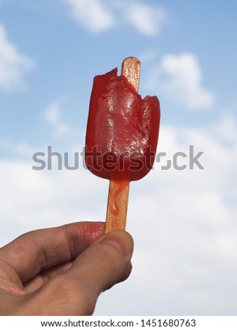 Refreshing strawberry popsicle against sky