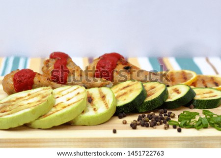 grilled chicken, zucchini and lemon, bright background, side view
