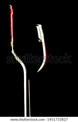 Contour of a glass with a bottle isolated on a black background