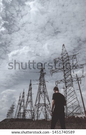 guy man standing on the background of electric wires