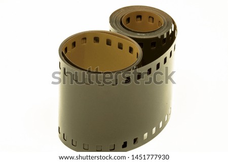 Rolled undeveloped film strip in white background