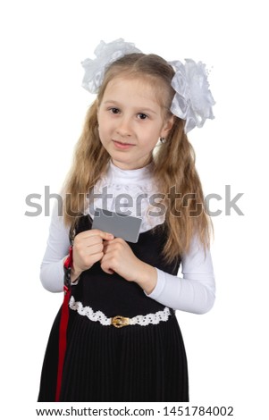 Little cute schoolgirl posing on a white background