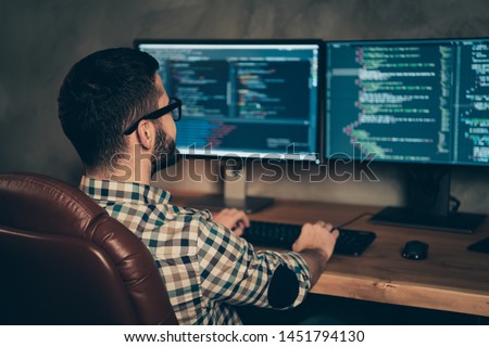 Profile side view of brunet bearded guy ceo boss chief executive designer professional expert specialist sitting in front of screen creating web site at wooden industrial interior work place station Royalty-Free Stock Photo #1451794130