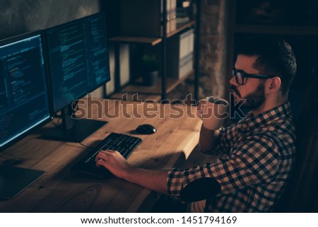 Close up side profile photo handsome mug hot beverage he him his guy coder typing php css keyboard development outsource IT processing two monitors table office agency wear specs formalwear shirt