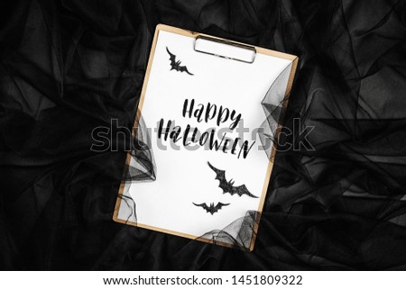Black   abstract background with clipboard and bats, concept for Halloween
