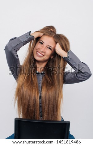 Portrait of a young stylish girl with long hair smiling, holding hands on face, looking at camera. Copy space. Isolated on white background.