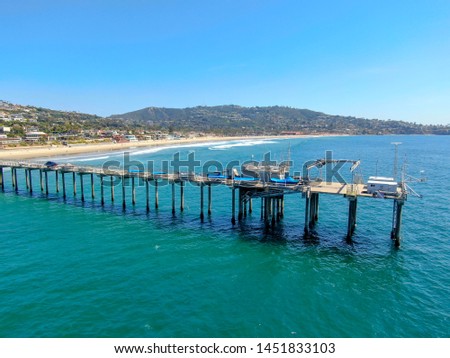 Aerial view of the scripps pier institute of oceanography, La Jolla, San Diego, California, USA. Research pier used to study ocean conditions and marine biology.  Pier with luxury villa on the coast.
