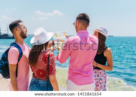 Tourists looking at a map and planning the places they are supposed to visit.