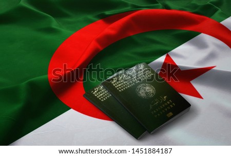 Algerian Passports on top of an Algerian Flag