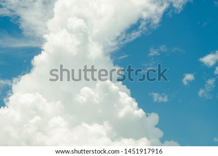 White Fluffy Cumulus Cloud on the Vivid Blue Sky in summer