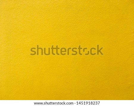 Yellow color concrete wall background and texture