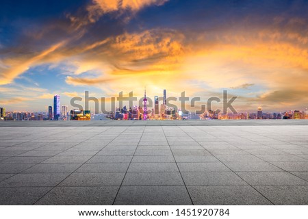 Empty square floor and modern city skyline in Shanghai at sunset,China