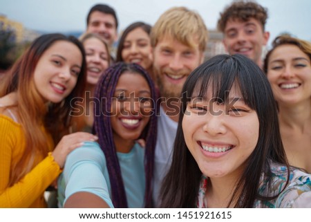 Friendship, leisure and summer concept - group of happy smiling friends outdoors. tourism, travel, people, leisure and technology concept. - image