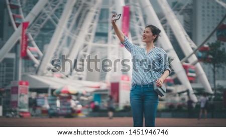 Asia woman using smartphone selfie on Hong Kong Central waterfront