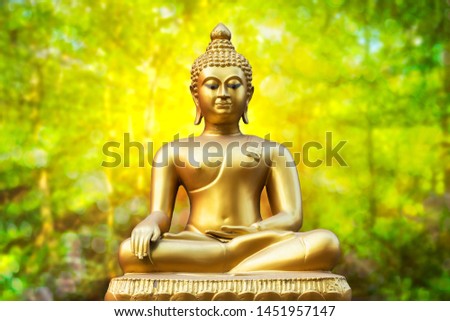 Beautiful of Golden Buddha statue on golden green bokeh background.