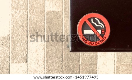 the safety first cautioned signage in front of the library is has a phrase about caution of no smoking