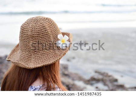 Still life with a hat On the background of clear blue sea water, a beach holiday.
