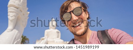 Man tourist on background of Big Buddha statue Was built on a high hilltop of Phuket Thailand Can be seen from a distance BANNER, LONG FORMAT