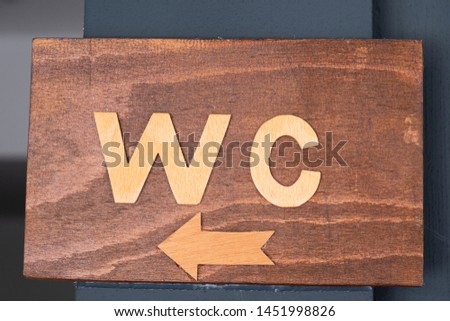 WC wooden  sign. Setting with WC sign