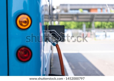 Electric bus stands at the charger