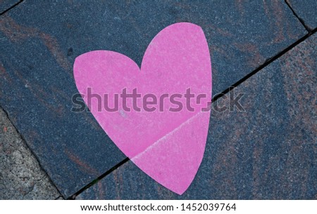 a pink heart on the pavement
