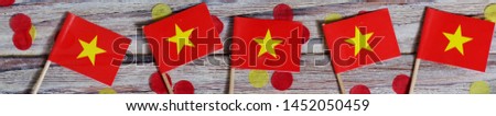 September 2, July 27, happy independence day Vietnam. memorial day for independence. the concept of patriotism. mini flags with confetti on white wooden background