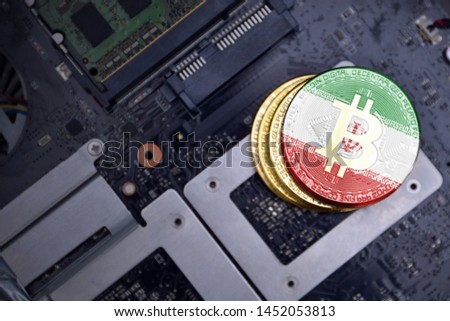 golden shining bitcoins with flag of iran on a computer electronic circuit board. bitcoin mining concept.
