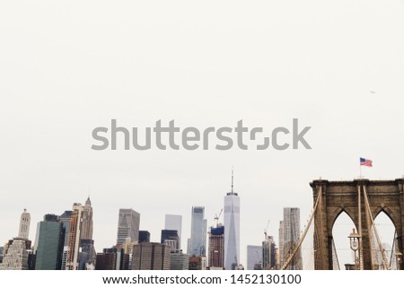 City skyline and bridge with US flag