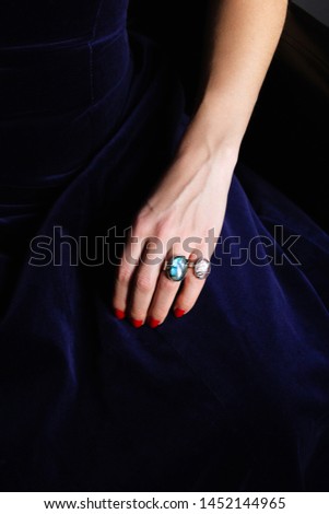 Silver rings with gemstones on woman hand