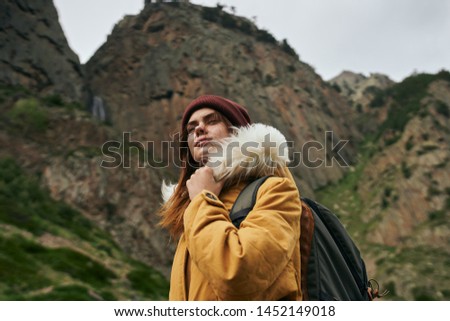 woman with backpack in the mountains