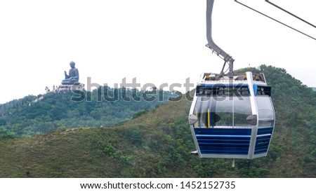 Hong Kong cable car over green mountain with Giant Buddha statue at Tian Tan, Po Lin monastery, Ngong Ping, Hong Kong city on isolated background