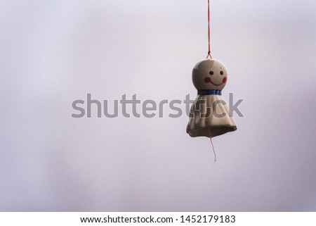 Hanging Doll stop rain made of ceramic white. A symbol of happiness