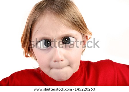 Little girl wearing red shirt isolated on white making funny face