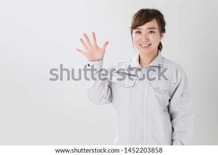Gesture of the woman in work clothes
