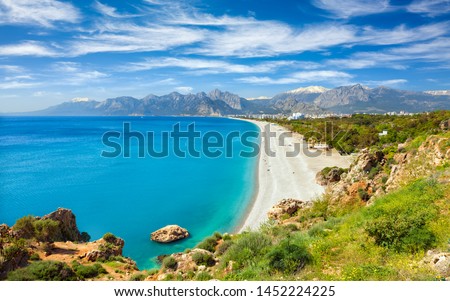 Aerial view of beautiful blue gulf and long Konyaalti beach in Antalya, Turkey. Antalya is Turkey's biggest international sea resort located on Turkish Riviera. Royalty-Free Stock Photo #1452224225