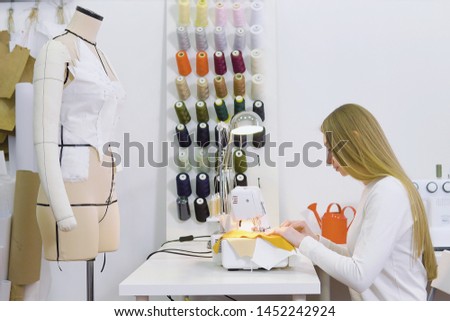 Dressmaker woman working with sewing machine Royalty-Free Stock Photo #1452242924