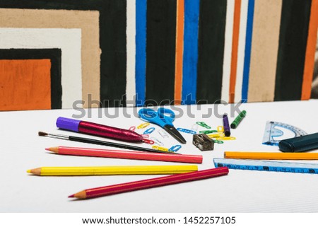 Stationery lying near abstract painting