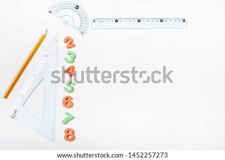 Rulers and pencil near figures