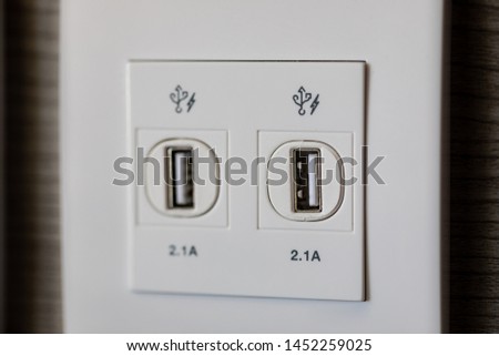USB slot is attached to the wall for charging. USB socket port with USB signage icon on wooden wall background, Prepared to use.