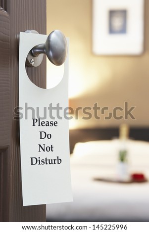 Do Not Disturb"" sign on hotel room's door Royalty-Free Stock Photo #145225996